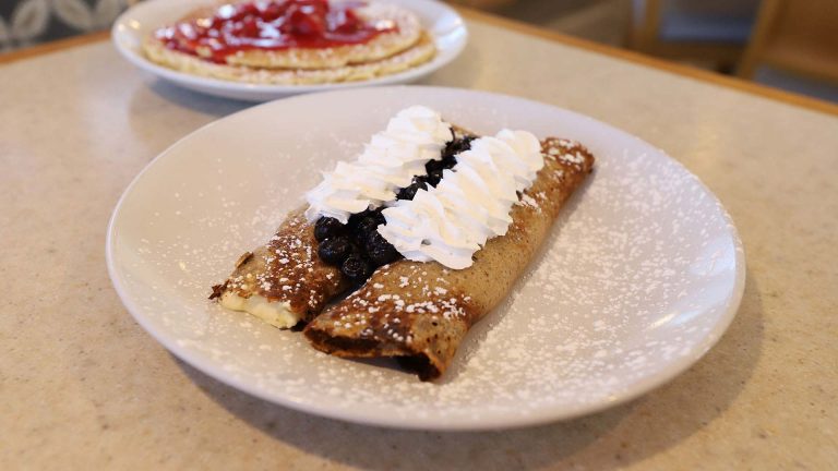 blueberry crepes covered in whipped cream