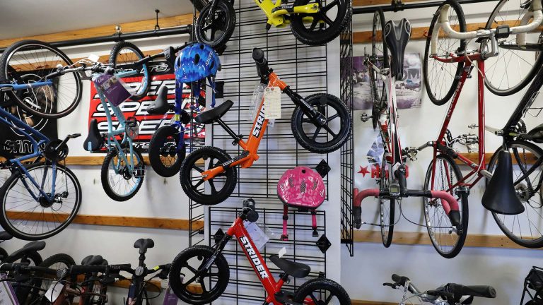 Bikes-N-Boards | Variety of bikes hanging from racks
