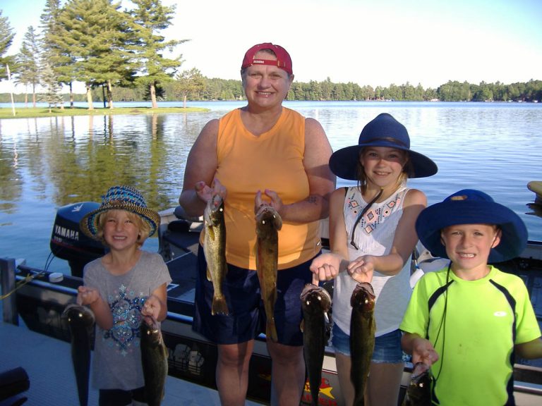 Captain Hooks Fishing Adventures | Mom and kids holding up their fishing catches