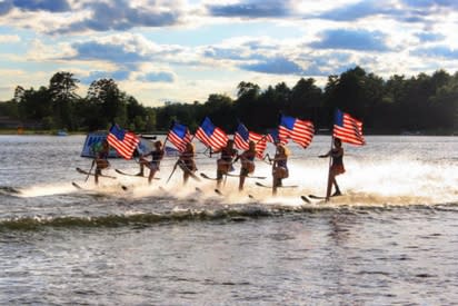 Min-Aqua Bats Water Ski Shows | Ski acrbats holding flags and skiing in unison