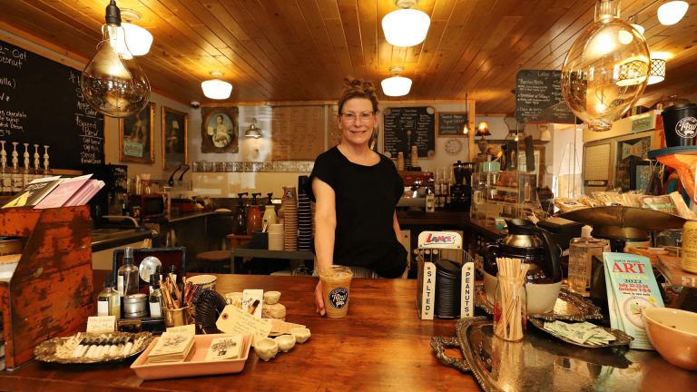 Woman at the counter serving coffee