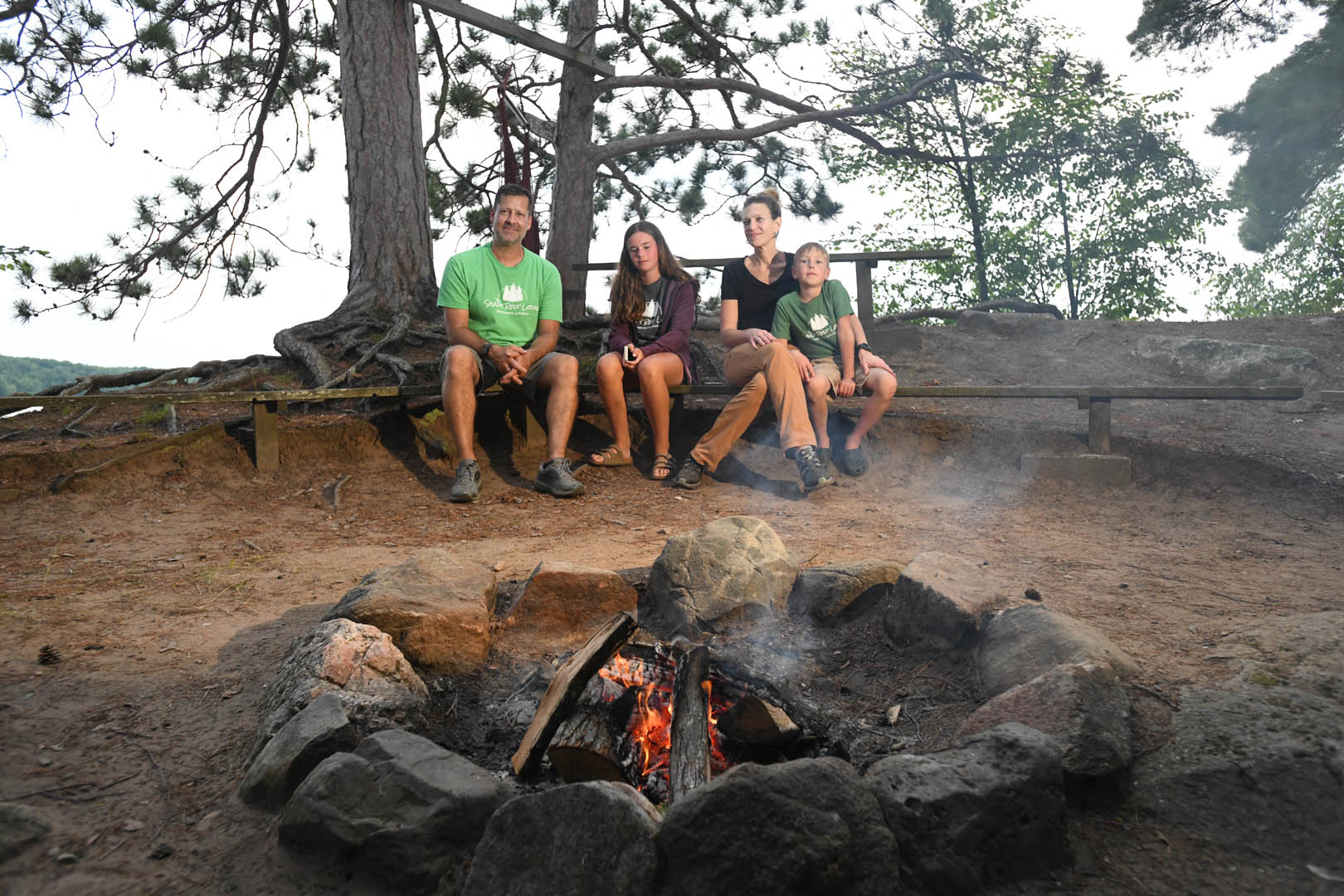Family relaxing by the campfire at Shady Rest Lodge