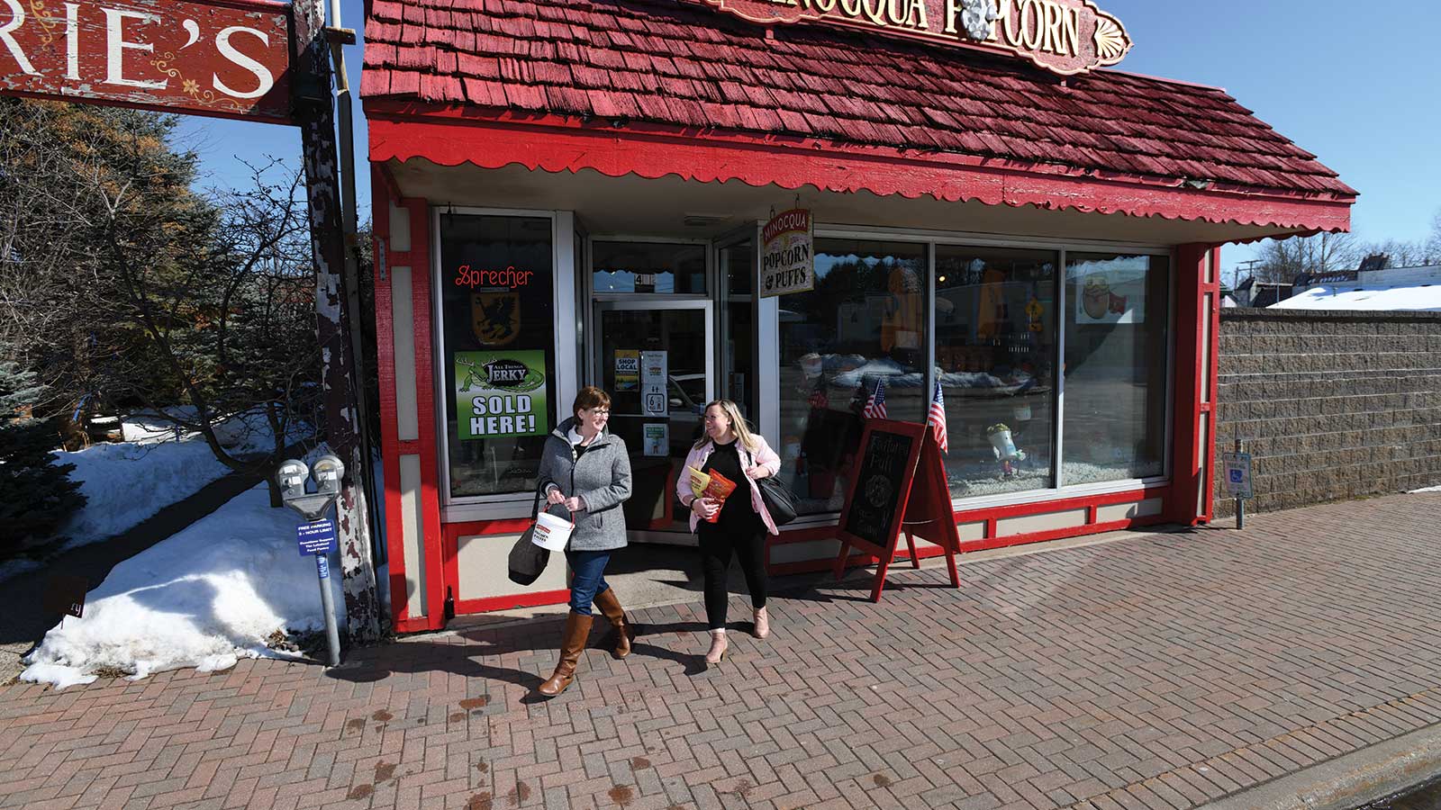 Some happy shoppers leaving Minocqua Popcorn and Puffs