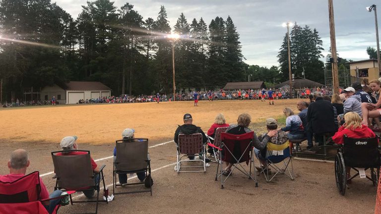 Related Article: Take in the fresh air at these summer events | People sitting in their foldout chairs watching a baseball game