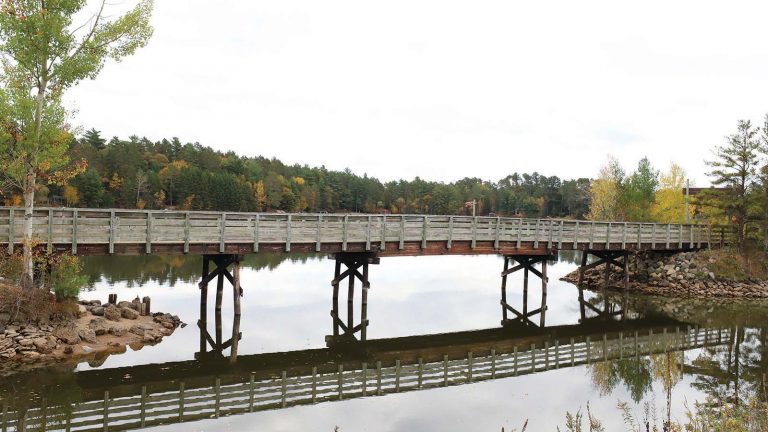 Related Article: Get out on the trails in Oneida County | Trail bridge going over a waterway surrounded by trees