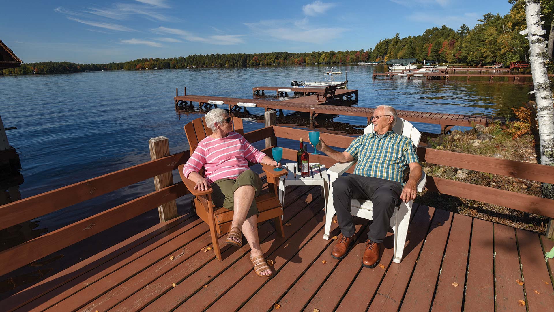 Old couple enjoying the beautiful fall day by the water at Hintz Cottages & Resorts