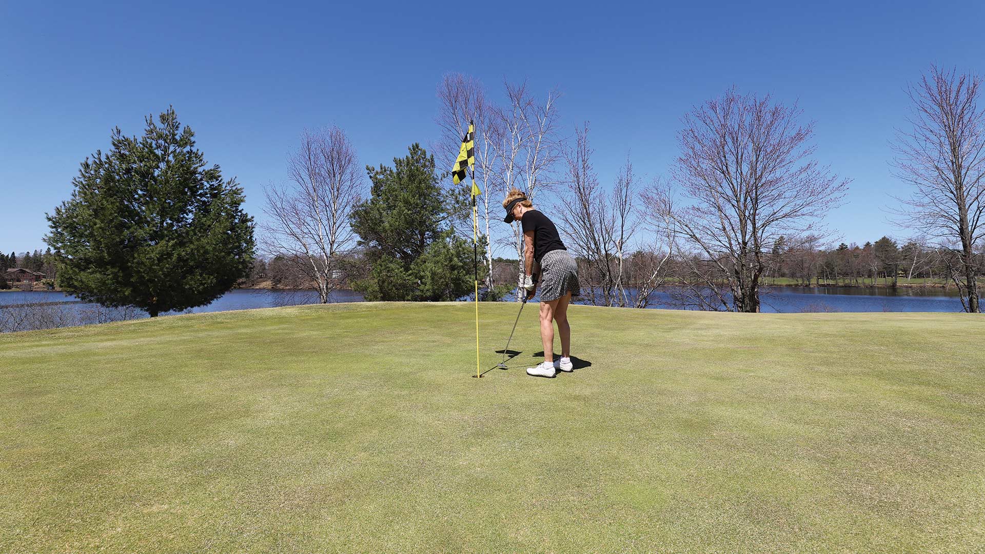 Woman sinking the put at Rhinelander Country Club