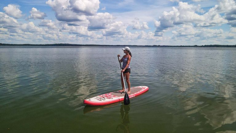 Woman paddle boarding Pelican Lake
