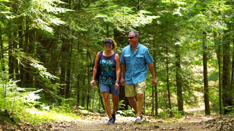 Couple hiking on trail in summer Oneida County WI