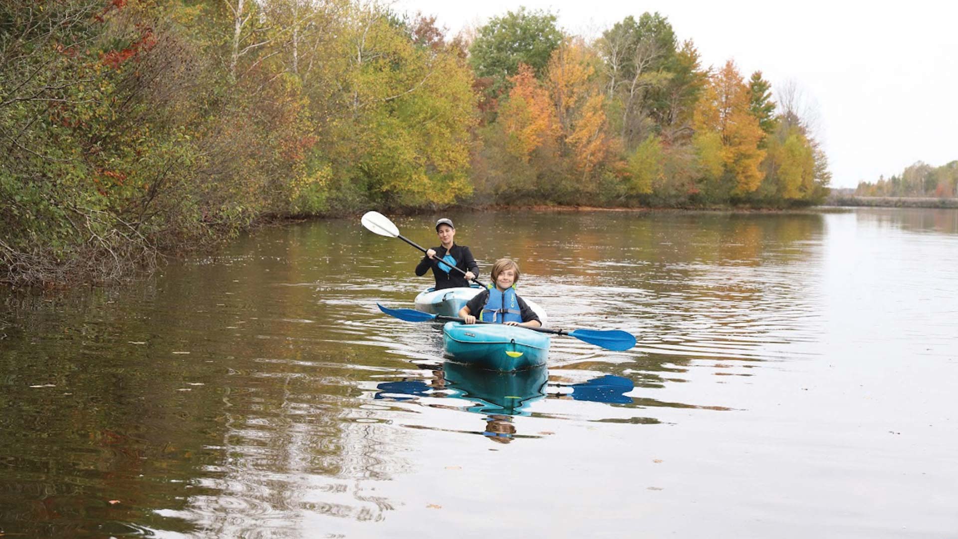 Mother and son kayaking the Wisconsin River during fall