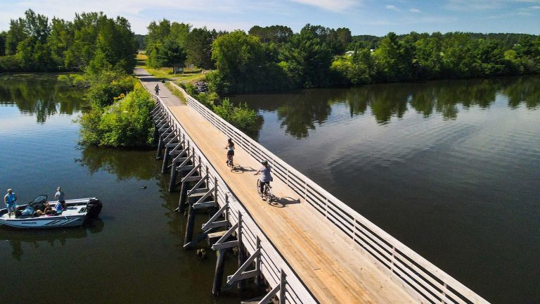 Biking | Bike riders on Trestle Bridge over water