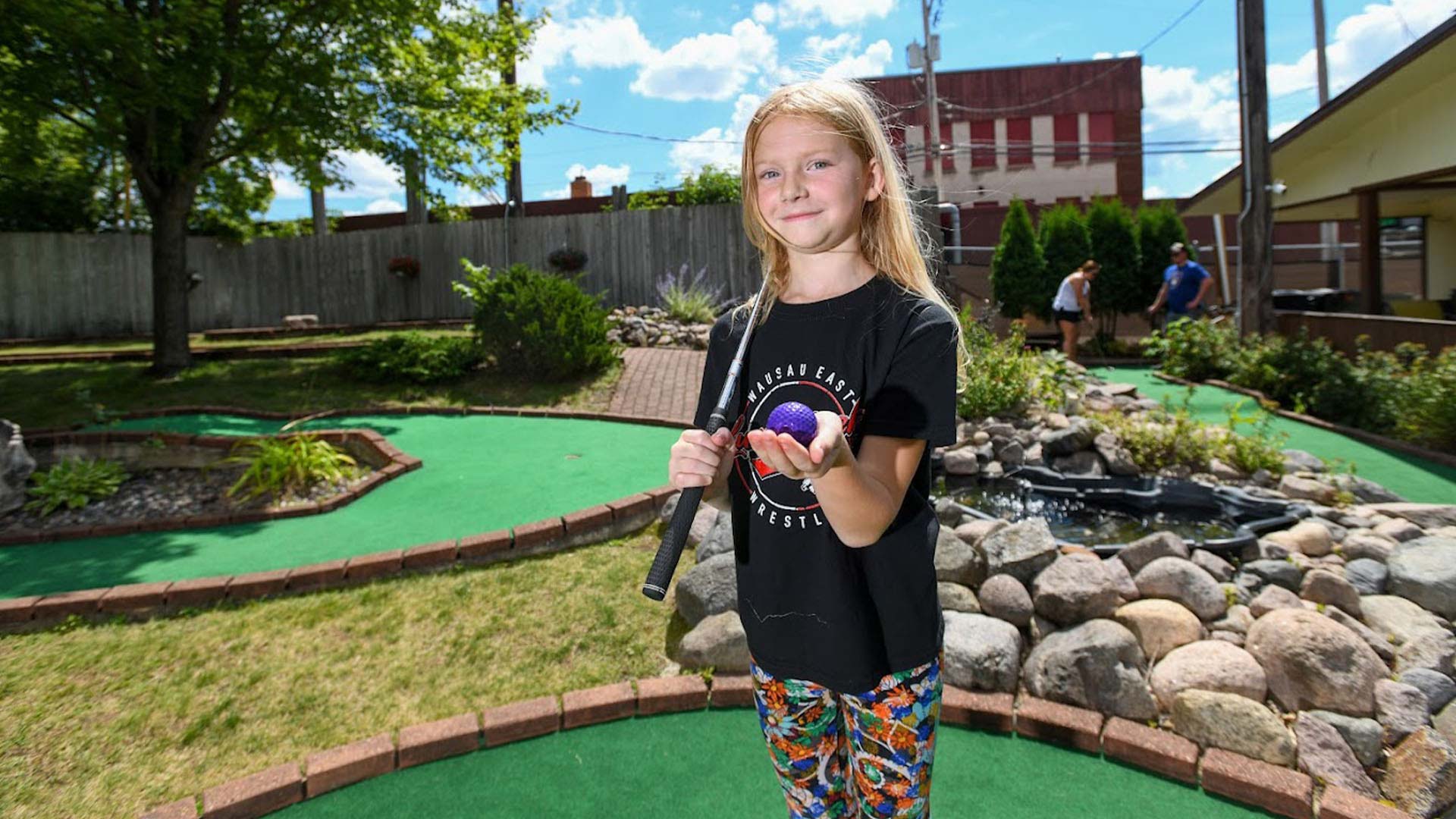 What to see & do in Oneida County | Girl holding a club and ball at Big Bear Mini Golf