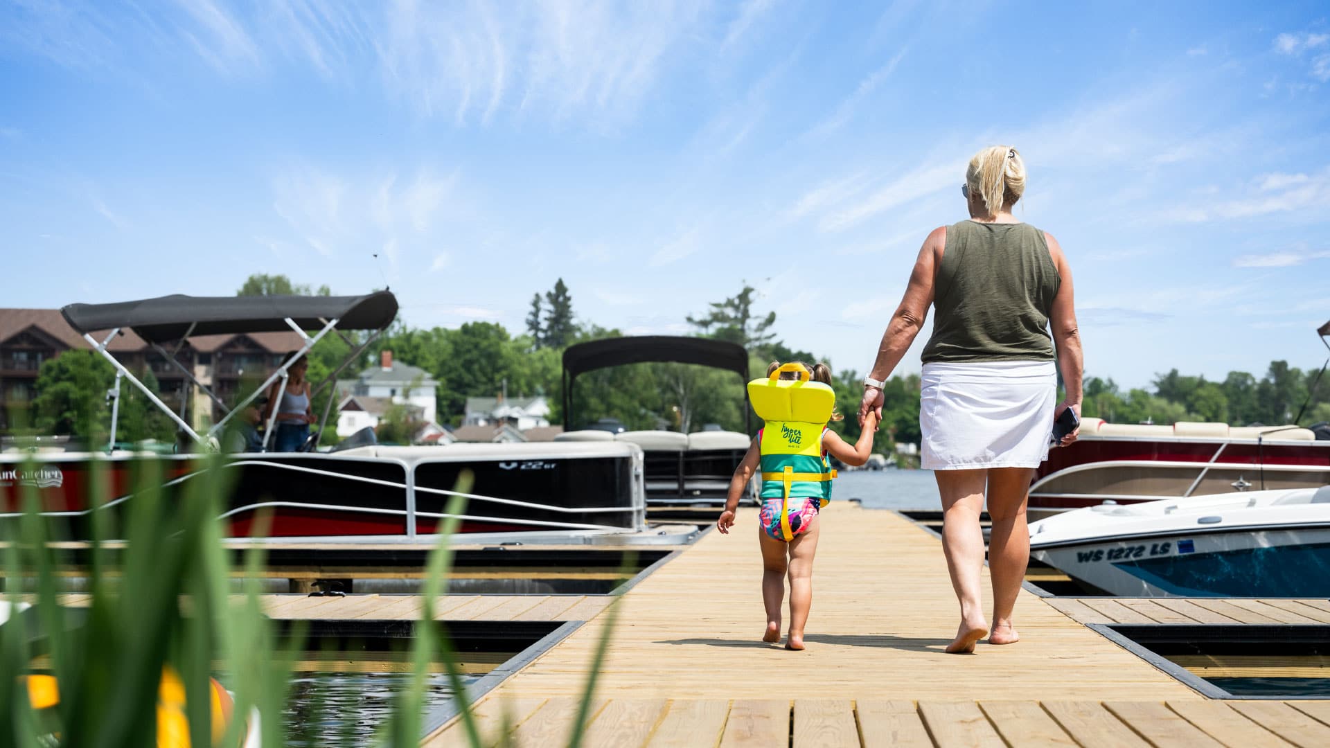 What to see and do in the Minocqua Area | Woman walking with child down dock