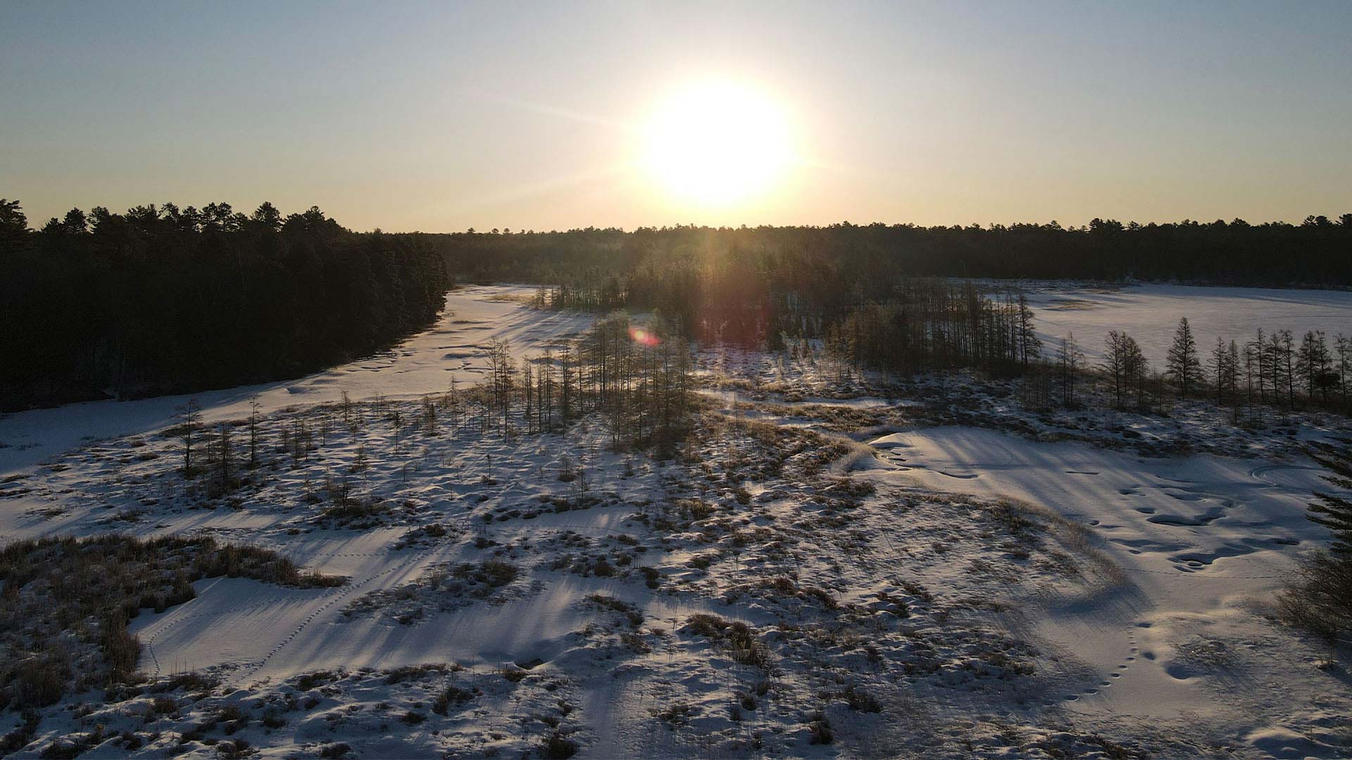 WINTER FUN IN ONEIDA COUNTY | Sunrise over the snow covered trees at Lake Minocqua