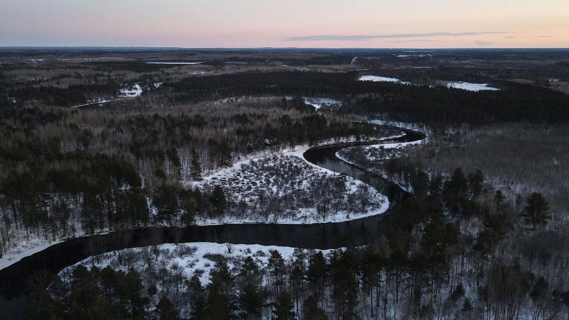 WINTER FUN IN ONEIDA COUNTY | Aerial shot of winding river surrounded by snow