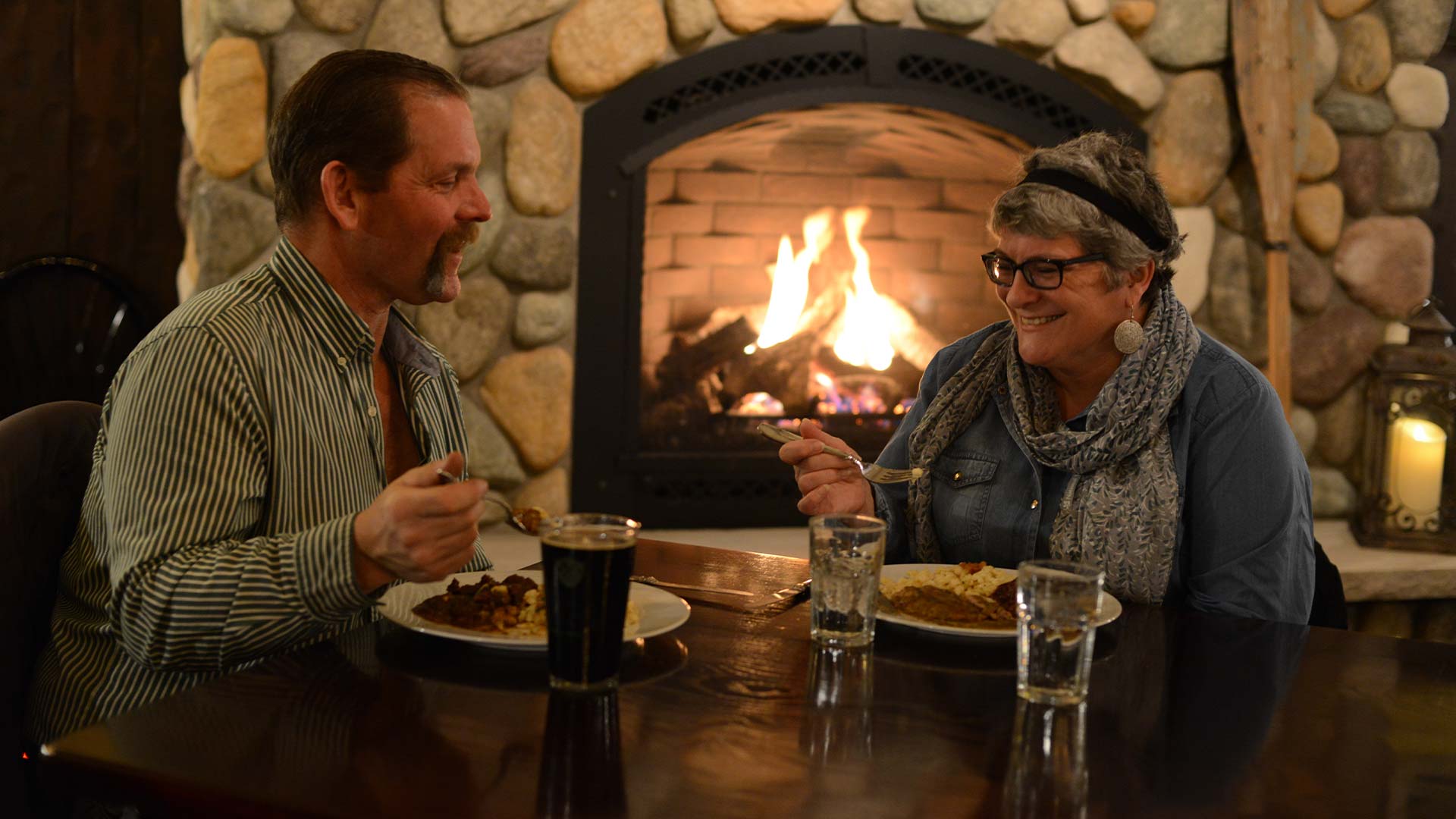 WINTER FUN IN ONEIDA COUNTY | Couple dining by the fire at Black Forest