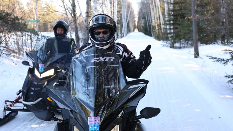 Related Article: Meet Oneida County’s snowmobile clubs | Two people on snowmobile trails near Three Lakes in Oneida County Wisconsin