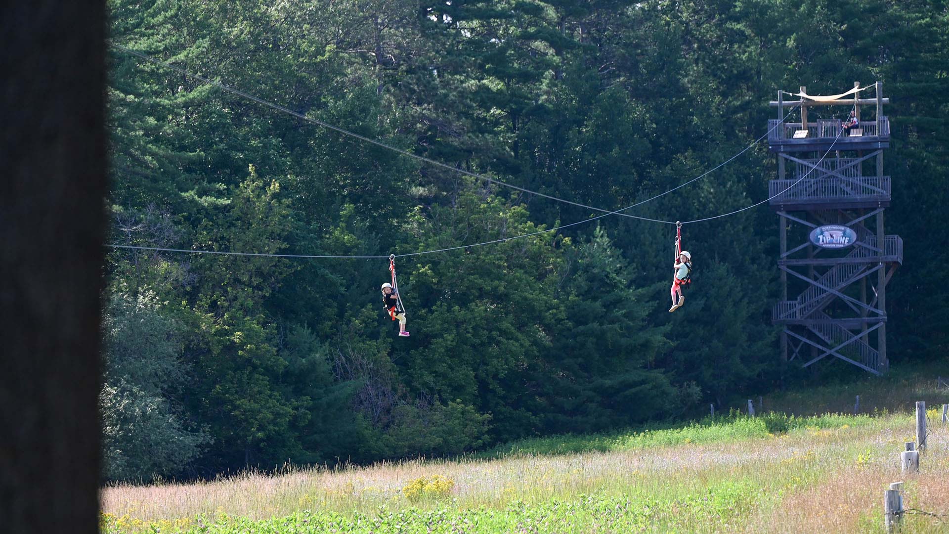 EXPLORE ONEIDA COUNTY THIS SPRING | People ziplining at Northwoods Zipline Adventure Tours