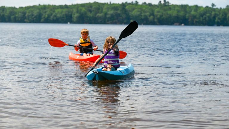 Canoeing, Kayaking & Paddleboarding | Brother and sister kayaking in front of Merry Dale Resort