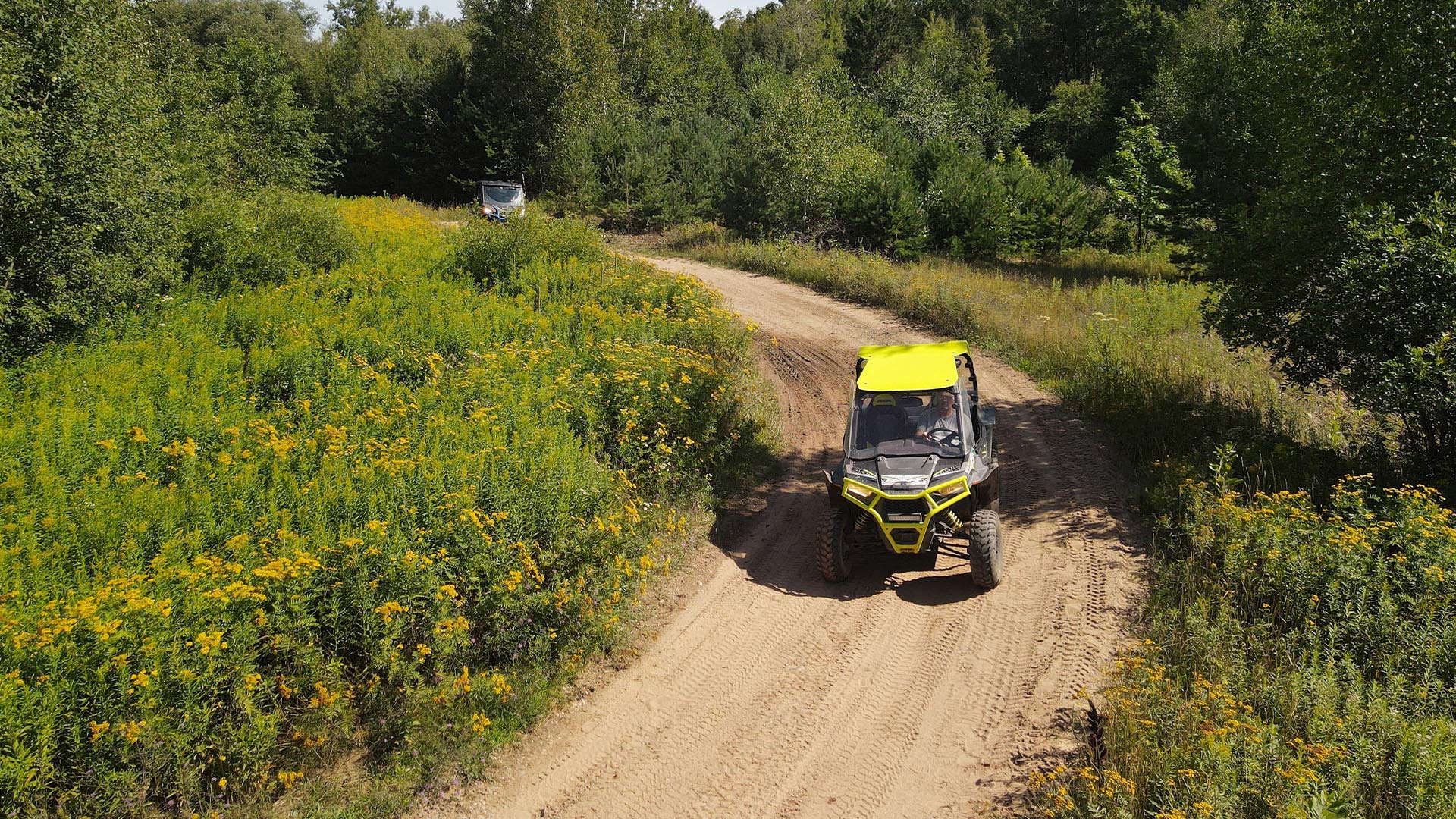 ATVing & UTVing | UTVs rounding the bend on a gravel trail