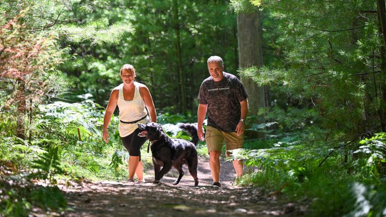 Hiking | Man and woman hiking with their dog
