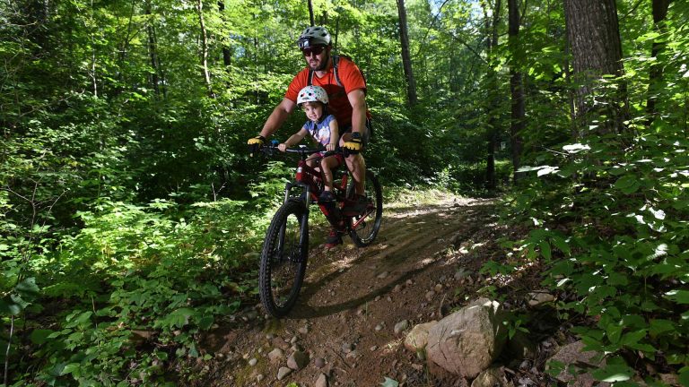 Biking | Man biking with his child on Washburn Lake Trail