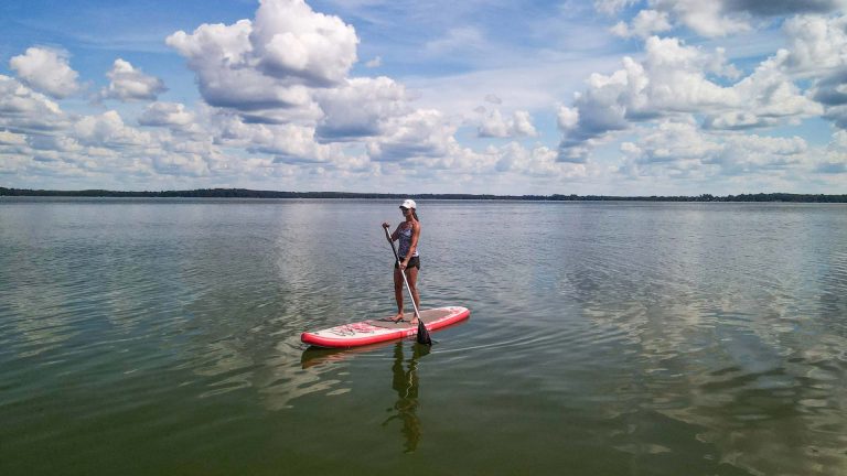 Related Article: Where to go canoeing & kayaking in Oneida County | Woman stand-up paddleboarding on Pelican Lake in Oneida County Wisconsin