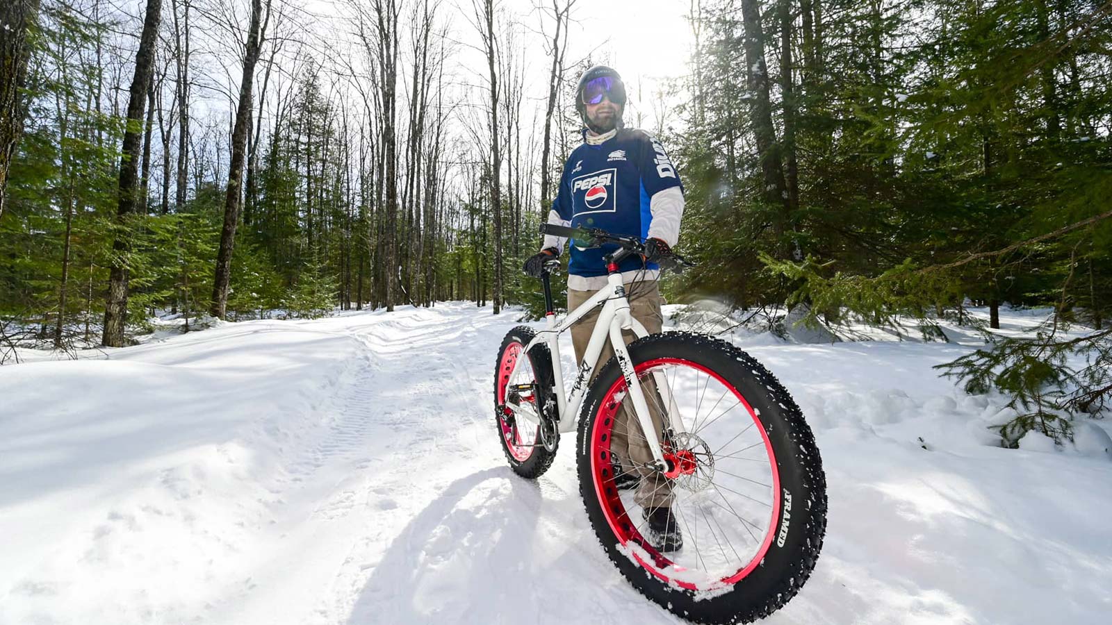 Where to go winter fatbiking in Oneida County | Man standing with fatbike in winter on Tara Lila Trails in northern Oneida County Wisconsin