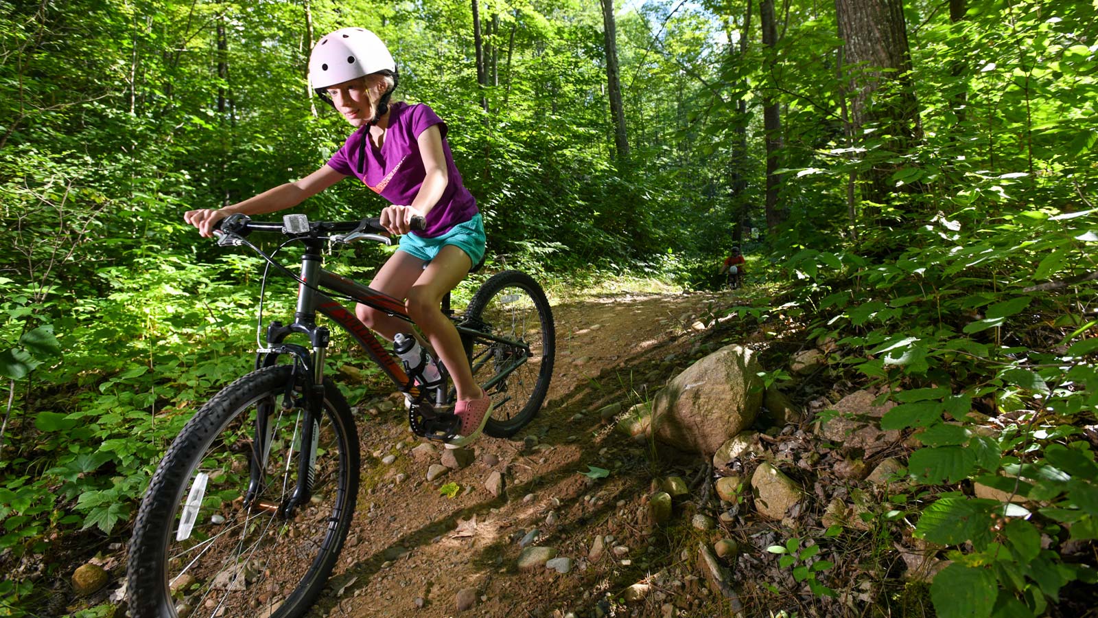 5 great mountain bike trails in Oneida County | Girl mountain biking on the Washburn Lake Trail in Woodboro in Oneida County Wisconsin