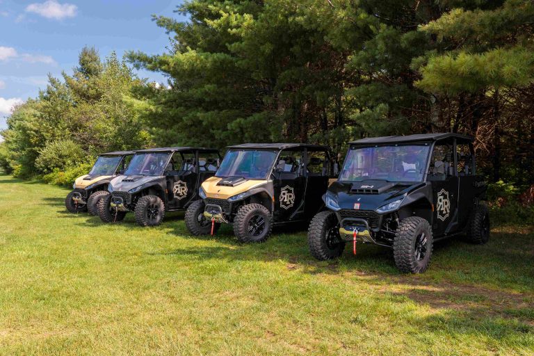 Rondele Ranch UTV Rentals | Side by side UTVs parked in grassy area near woods