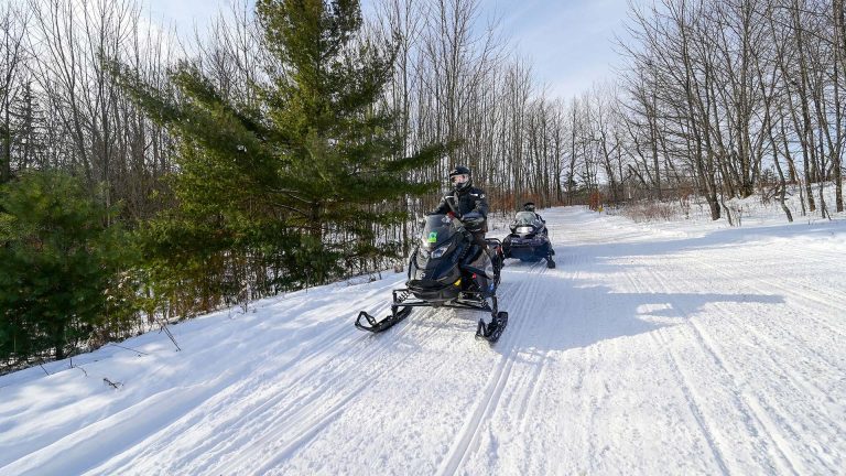 Snowmobiling | Two snowmobiles out on the trails