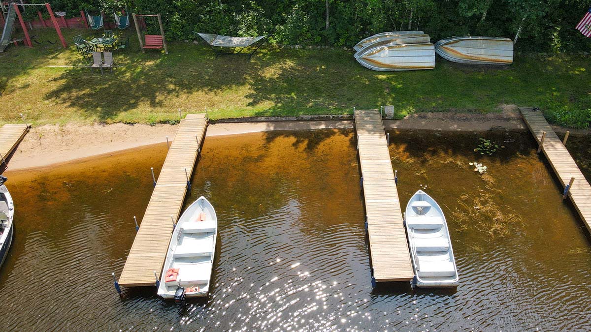 Plan Your Summer Vacation to Oneida County | Aerial view of rowboats resting at docks in front of Brekke's Fireside Resort